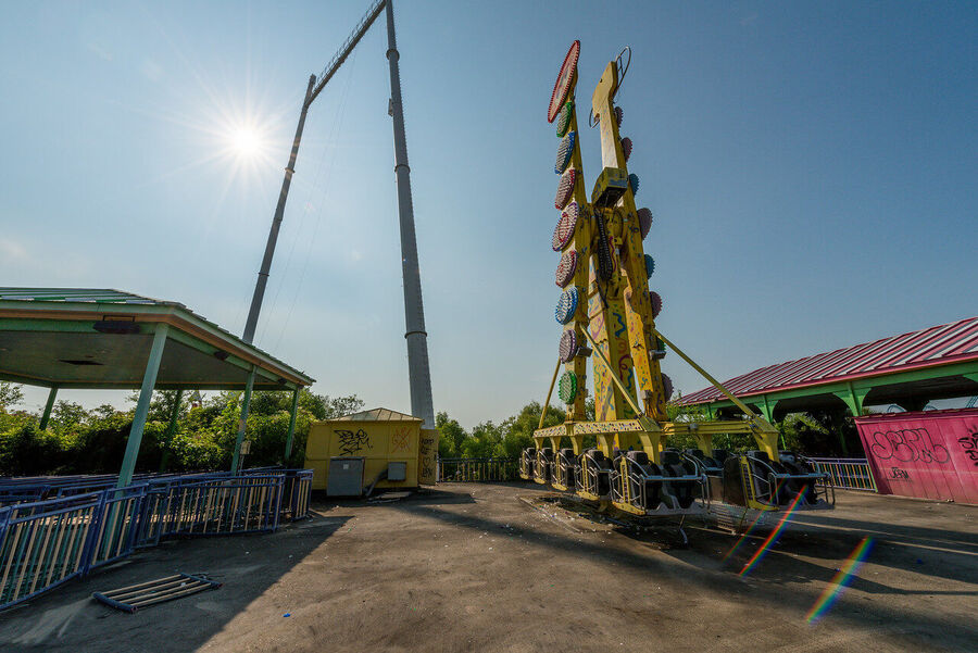 Fine art photograph of an abandoned amusement park building overtaken by tropical vegetation, a meditation on time and entropy