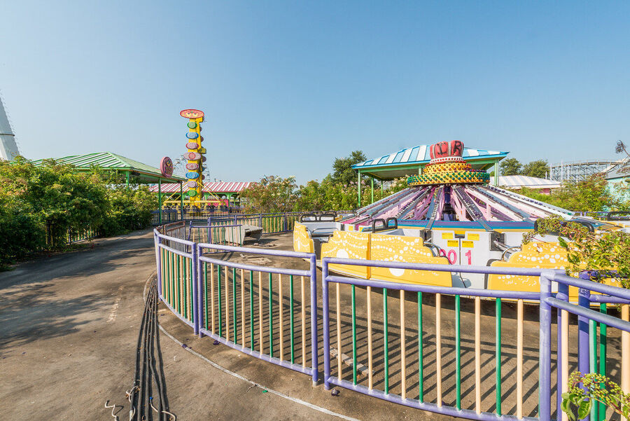 Fine art urban exploration photograph of abandoned Six Flags New Orleans roller coaster structure, nature reclaiming concrete and steel
