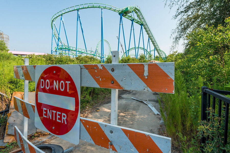 Fine art photograph of an abandoned amusement park building overtaken by tropical vegetation, a meditation on time and entropy