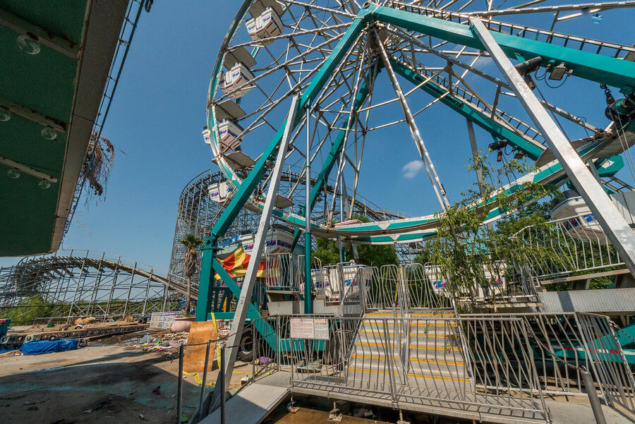 Fine art photograph of an abandoned amusement park building overtaken by tropical vegetation, a meditation on time and entropy