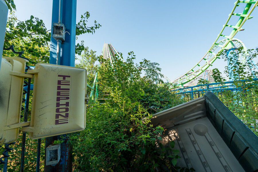 Fine art photograph of an abandoned amusement park building overtaken by tropical vegetation, a meditation on time and entropy