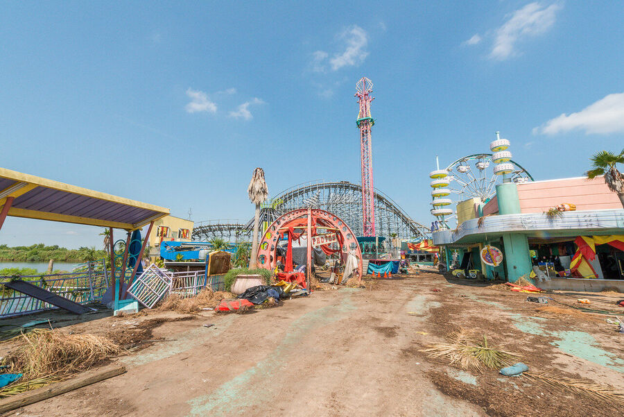 Fine art photograph of an abandoned amusement park building overtaken by tropical vegetation, a meditation on time and entropy