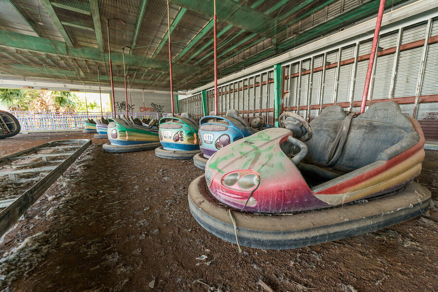 Fine art photograph of an abandoned amusement park building overtaken by tropical vegetation, a meditation on time and entropy