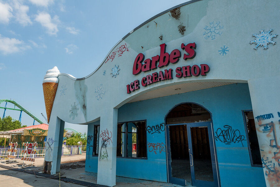 Fine art photograph of an abandoned amusement park building overtaken by tropical vegetation, a meditation on time and entropy