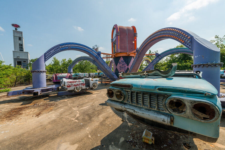Fine art photograph of an abandoned amusement park building overtaken by tropical vegetation, a meditation on time and entropy