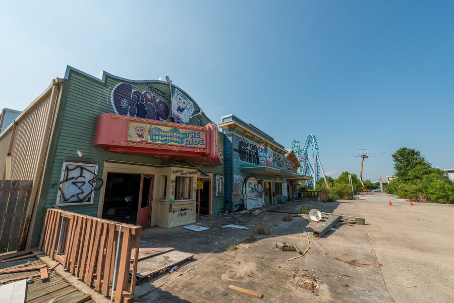 Fine art photograph of an abandoned amusement park building overtaken by tropical vegetation, a meditation on time and entropy