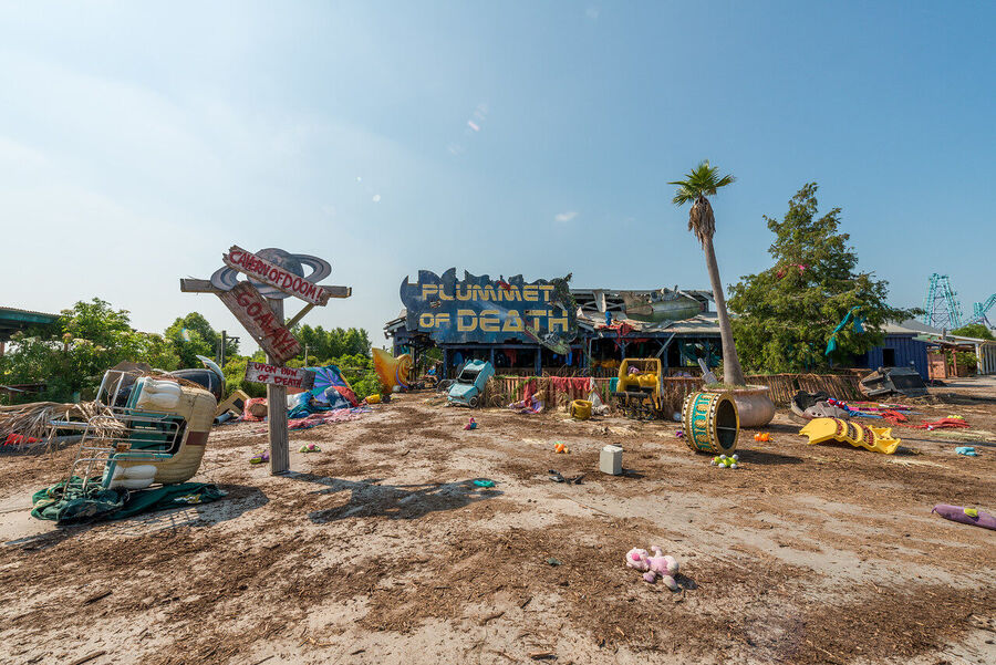 Large format fine art print of the derelict Six Flags New Orleans park at golden hour, rust and vegetation creating an atmosphere of quiet desolation