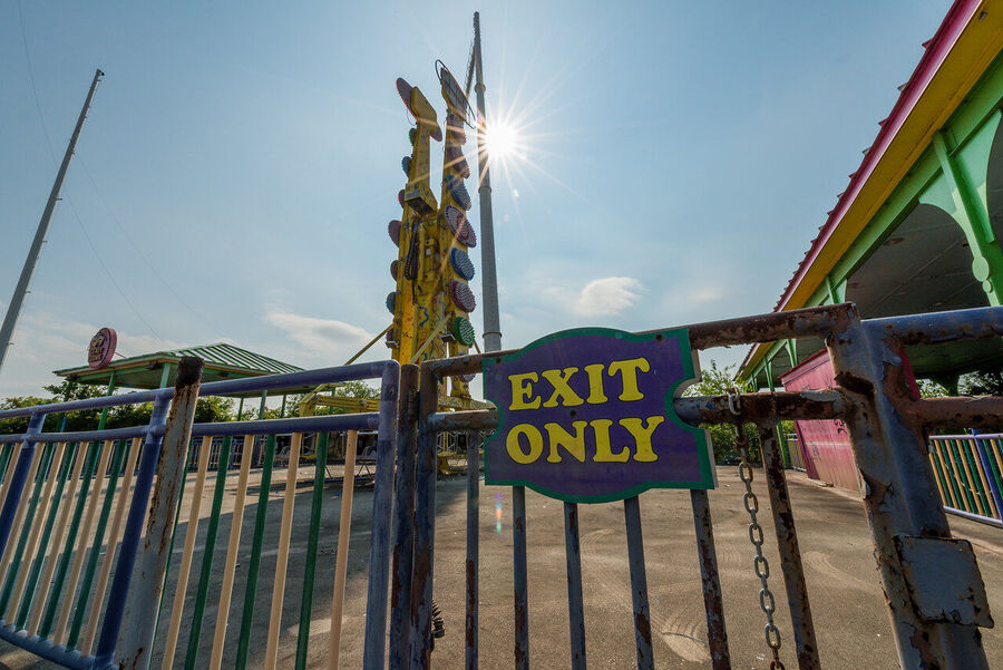 Fine art photograph of an abandoned amusement park building overtaken by tropical vegetation, a meditation on time and entropy