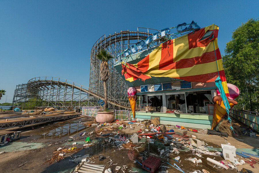 Fine art photograph of an abandoned amusement park building overtaken by tropical vegetation, a meditation on time and entropy
