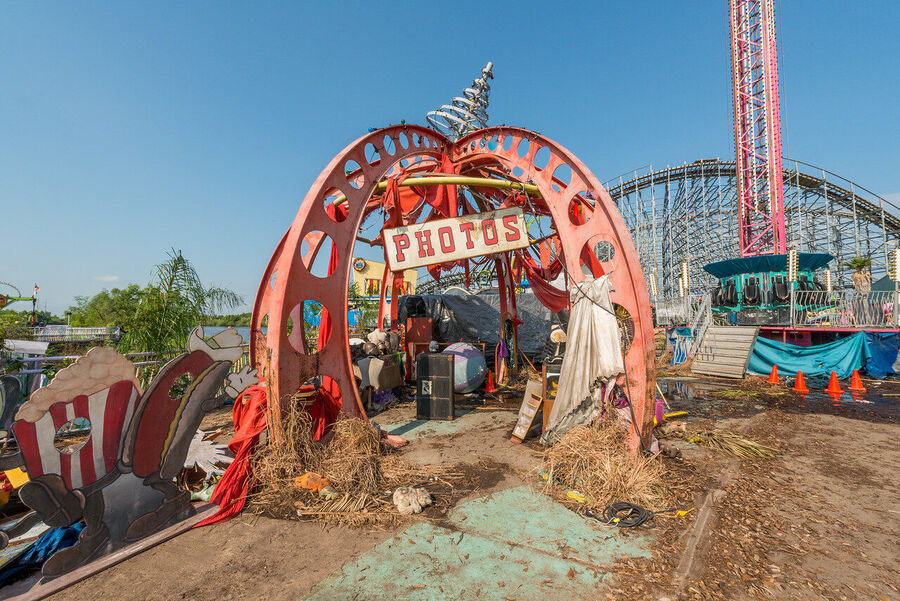 Large format fine art print of the derelict Six Flags New Orleans park at golden hour, rust and vegetation creating an atmosphere of quiet desolation