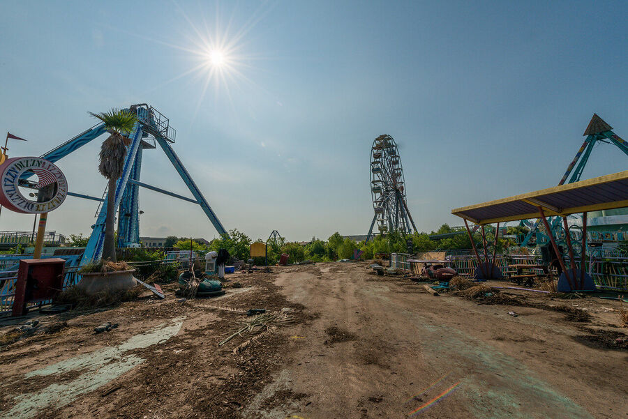 Fine art photograph of an abandoned amusement park building overtaken by tropical vegetation, a meditation on time and entropy