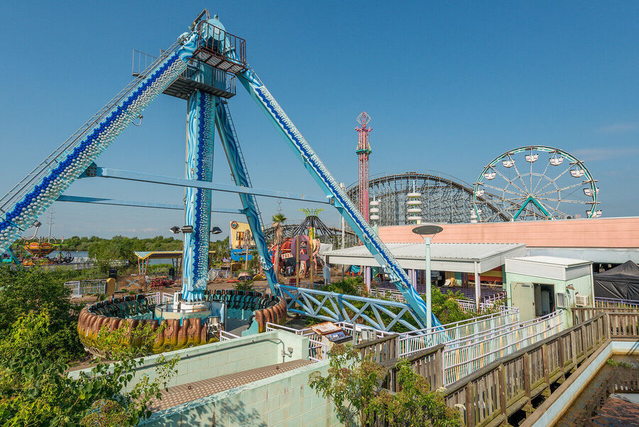 Fine art photograph of an abandoned amusement park building overtaken by tropical vegetation, a meditation on time and entropy