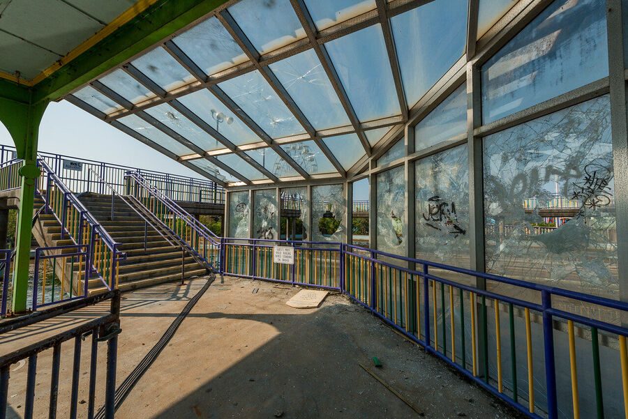 Fine art urban exploration photograph of abandoned Six Flags New Orleans roller coaster structure, nature reclaiming concrete and steel