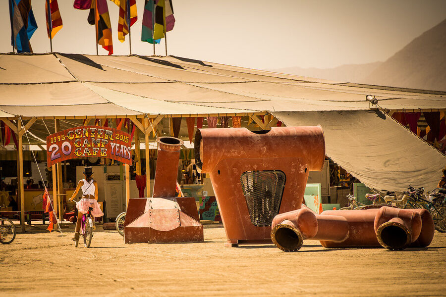Fine art photograph of the playa at Black Rock City at pre-dawn, total darkness broken only by installation lighting and stars