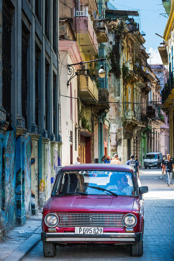 Street fine art photography print of Havana's crumbling colonial architecture bathed in late afternoon sun, shadows long on cobblestone streets