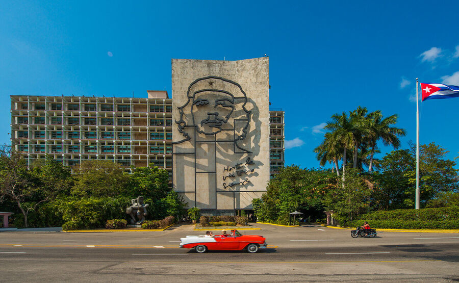 Fine art documentary print capturing everyday Havana life — a quiet street scene of extraordinary human warmth and architectural grandeur