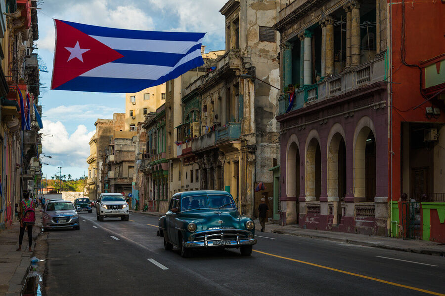 Wide format fine art photograph of Havana harbor at twilight, the city's distinctive skyline silhouetted against the last light over the Caribbean
