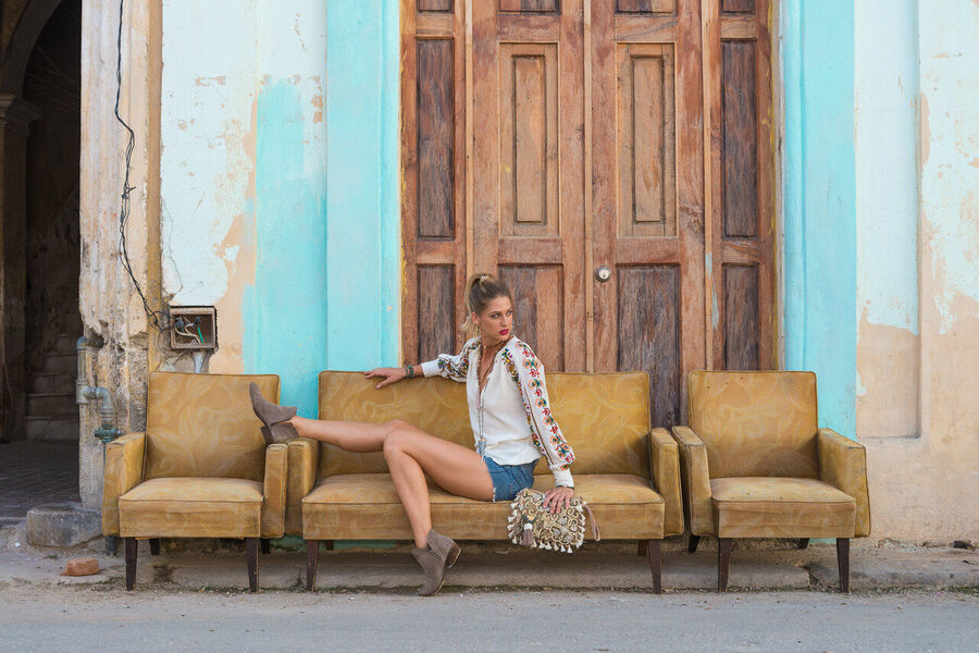 Fine art documentary print of a Havana musician performing in a sun-drenched colonial courtyard, dappled light falling across warm terracotta walls