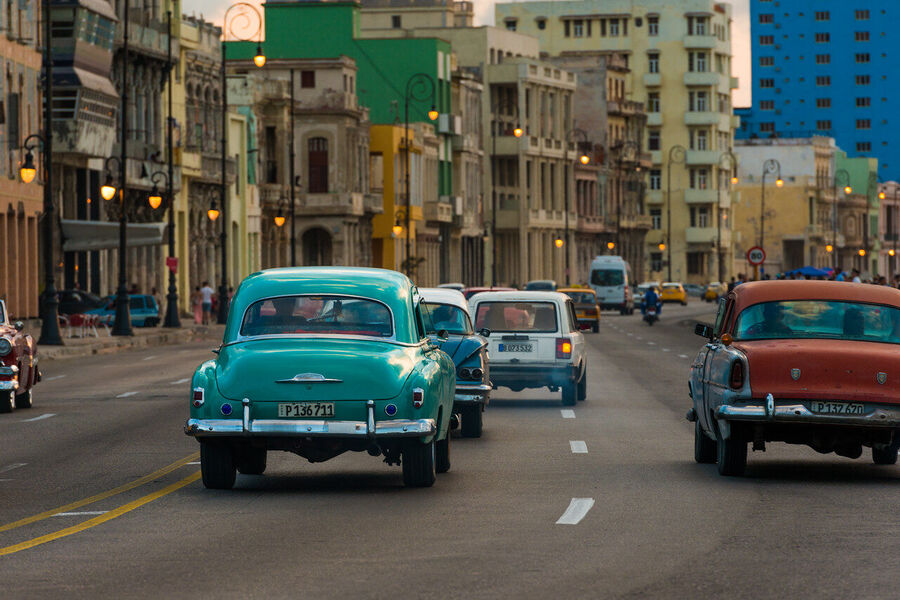 Street fine art photography print of Havana's crumbling colonial architecture bathed in late afternoon sun, shadows long on cobblestone streets