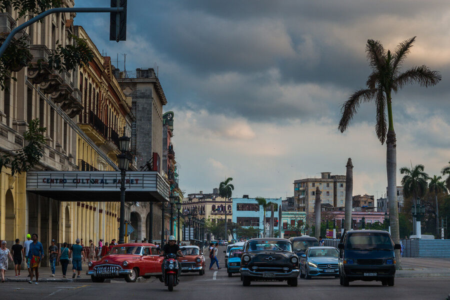 Wide format fine art photograph of Havana harbor at twilight, the city's distinctive skyline silhouetted against the last light over the Caribbean