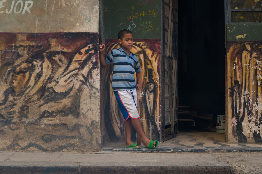 Street fine art photography print of Havana's crumbling colonial architecture bathed in late afternoon sun, shadows long on cobblestone streets