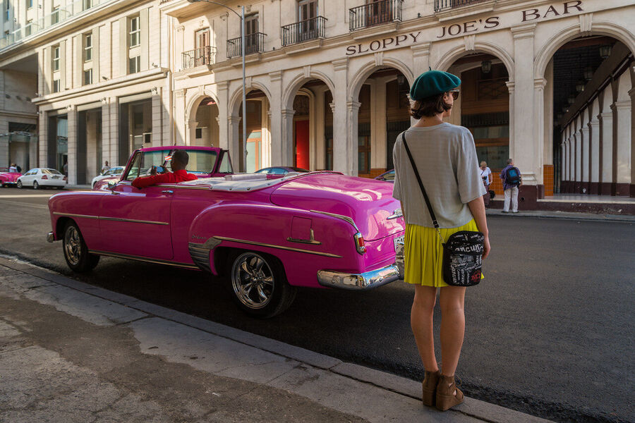 Fine art street photography print of colorful vintage taxis idling along a Havana boulevard, the city's timeless patina on full display