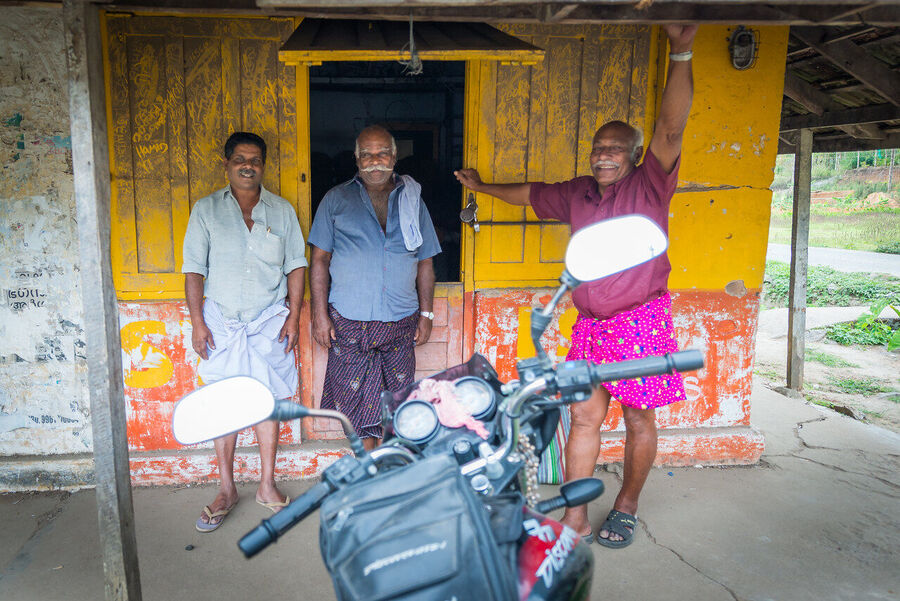 Fine art street photography print from Kerala's backwaters, everyday life along the water channels captured with warmth and compositional precision