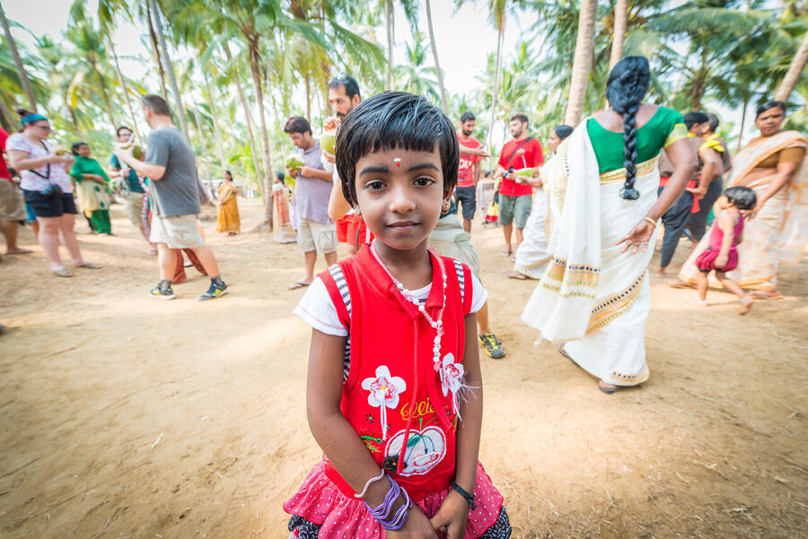 Fine art photograph of a young Indian student in school uniform, clear afternoon light making her direct gaze impossible to look away from