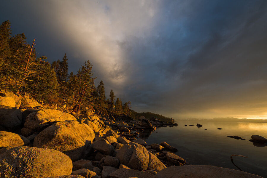 Fine art nature print of Lake Tahoe's rocky eastern shoreline with crystal-clear submerged stones visible through the water at dawn