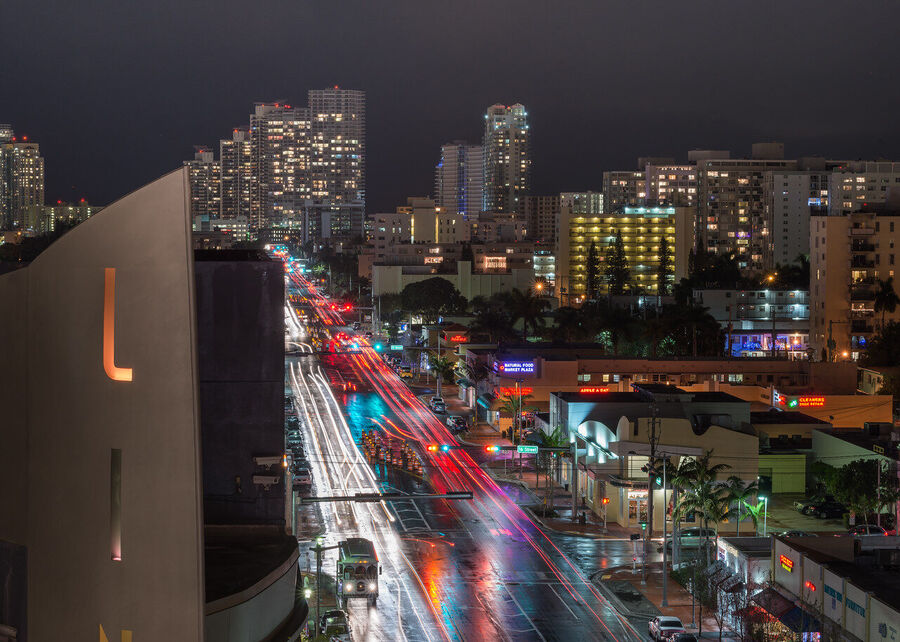Dramatic fine art landscape print of Miami's urban skyline framed by stormy cloud formations at the blue hour