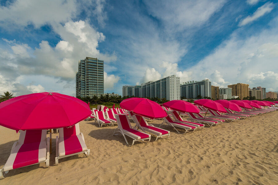 Fine art urban landscape photograph of Miami's downtown financial district towers rising through a coral-toned evening sky