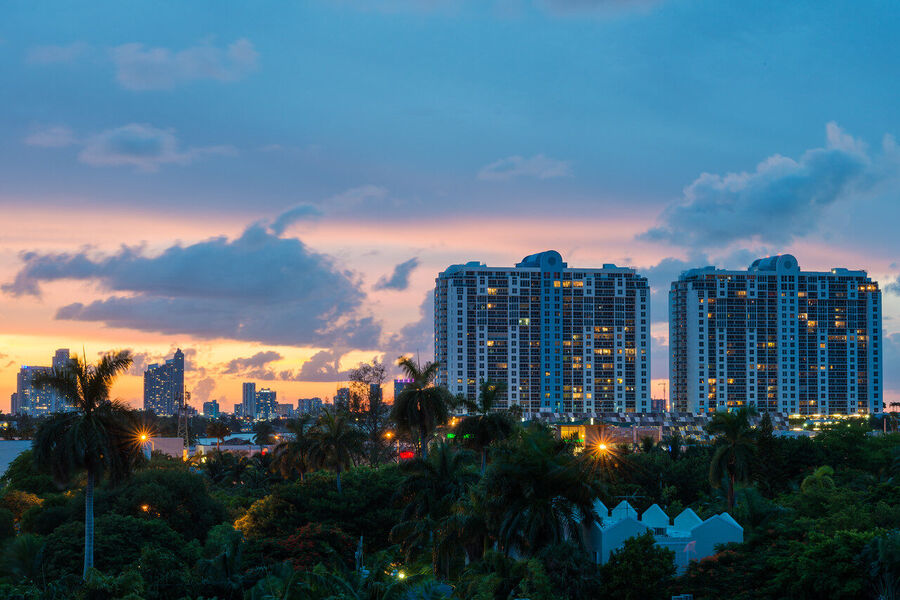 Dramatic fine art landscape print of Miami's urban skyline framed by stormy cloud formations at the blue hour