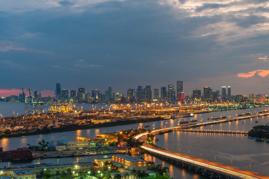 Fine art urban landscape photograph of Miami's downtown financial district towers rising through a coral-toned evening sky