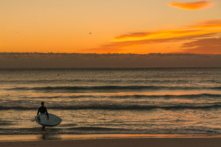 Fine art photography print of a solitary Miami Beach lifeguard tower silhouetted against a flamingo-toned sunrise sky