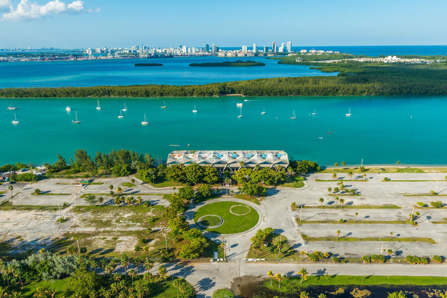 Wide angle fine art print of South Beach's ocean-facing shoreline at golden hour, waves catching the last warm light