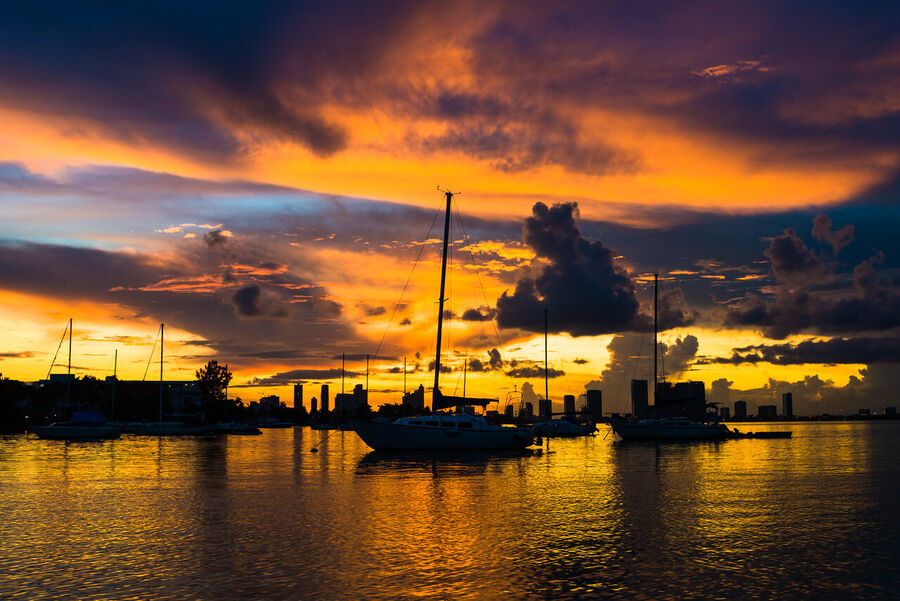 Dramatic fine art landscape print of Miami's urban skyline framed by stormy cloud formations at the blue hour