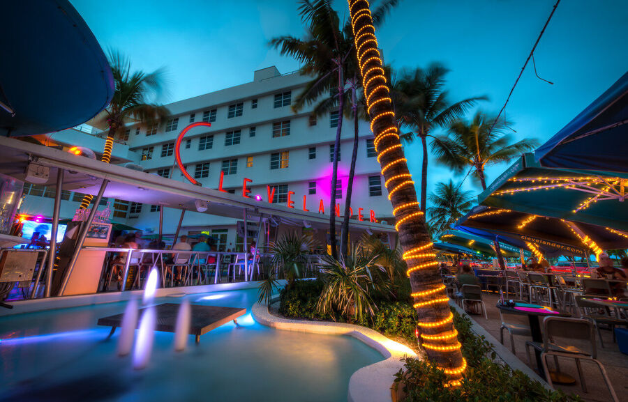 Wide angle fine art print of South Beach's ocean-facing shoreline at golden hour, waves catching the last warm light