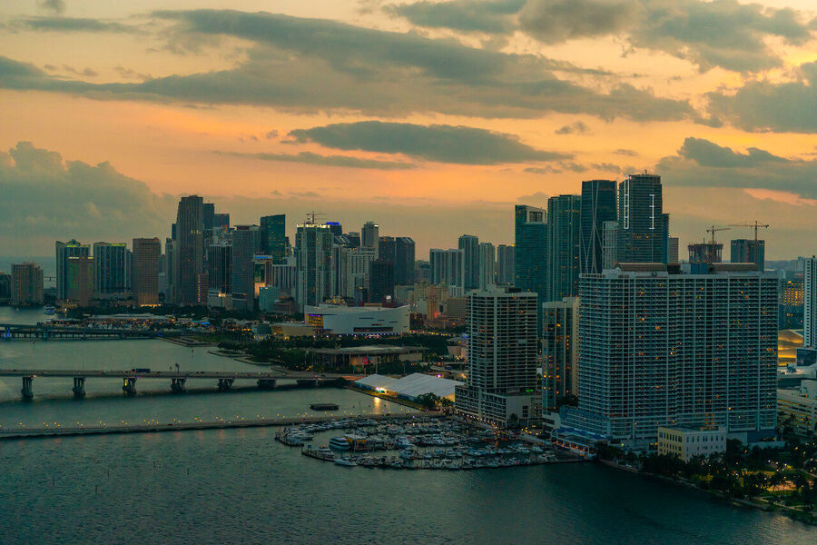 Fine art urban landscape photograph of Miami's downtown financial district towers rising through a coral-toned evening sky