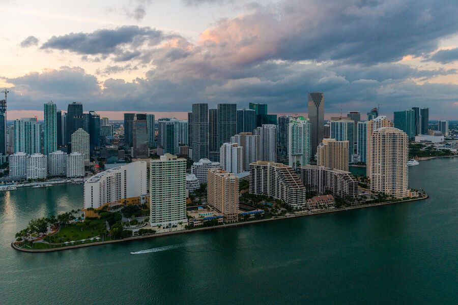 Wide angle fine art print of South Beach's ocean-facing shoreline at golden hour, waves catching the last warm light