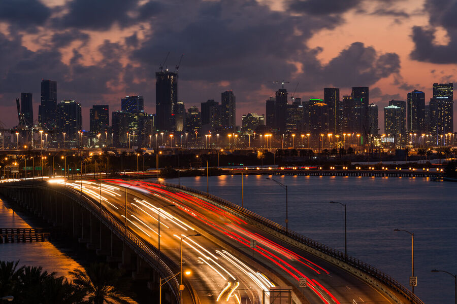 Dramatic fine art landscape print of Miami's urban skyline framed by stormy cloud formations at the blue hour