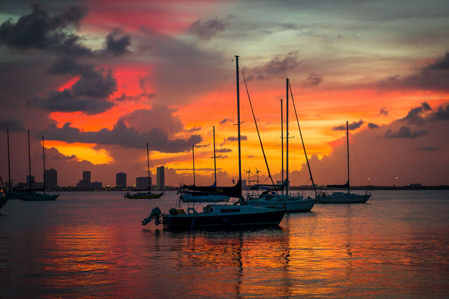 Fine art photography print of a solitary Miami Beach lifeguard tower silhouetted against a flamingo-toned sunrise sky