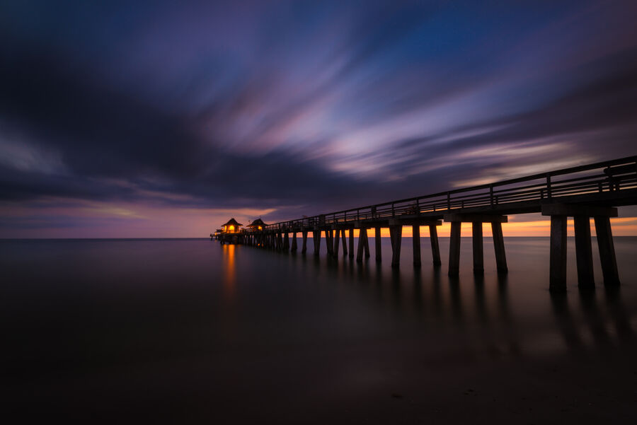 Large format fine art photograph of Naples Beach at golden hour, wet sand reflecting the sky in a perfect geometric composition